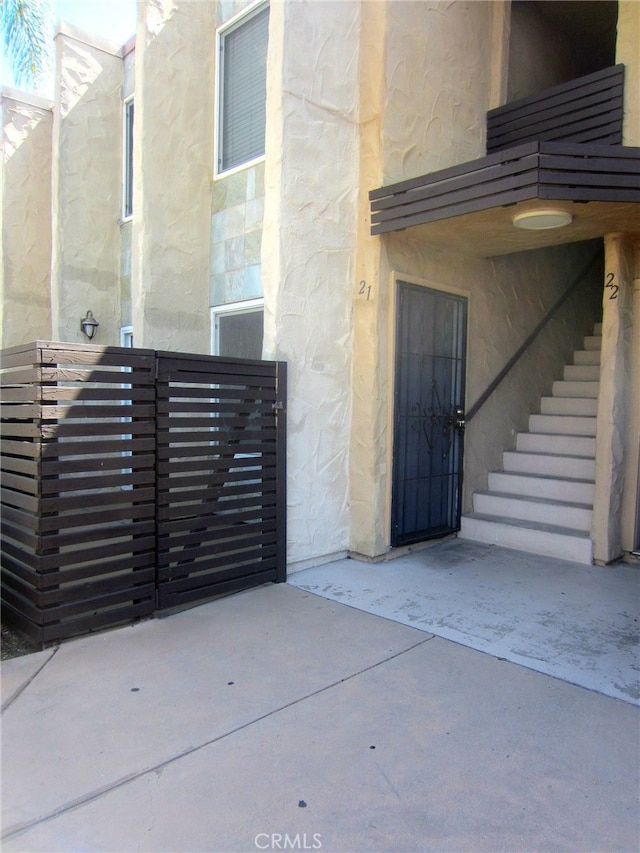 1386 E Madison Ave Unit 21, El Cajon, CA 92021 - view of exterior entry featuring a gate and stone siding
