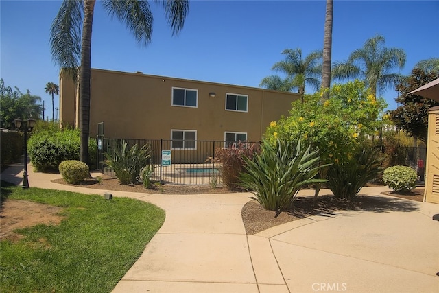 1386 E Madison Ave Unit 21, El Cajon, CA 92021 - view of building exterior with a community pool