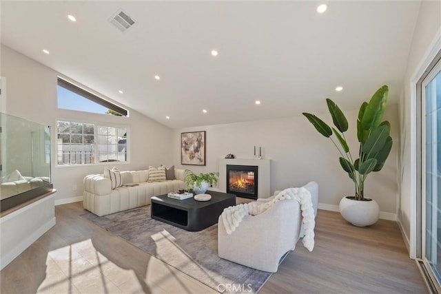 7372 Brian Ln, La Palma, CA 90623 - living area featuring recessed lighting, a glass covered fireplace, wood finished floors, and vaulted ceiling