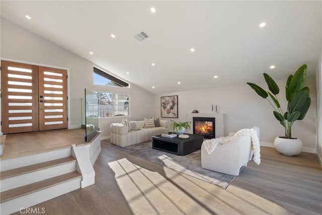 7372 Brian Ln, La Palma, CA 90623 - living room with lofted ceiling, a glass covered fireplace, wood finished floors, and recessed lighting