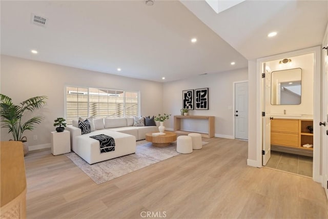 7372 Brian Ln, La Palma, CA 90623 - living room with light wood finished floors and recessed lighting