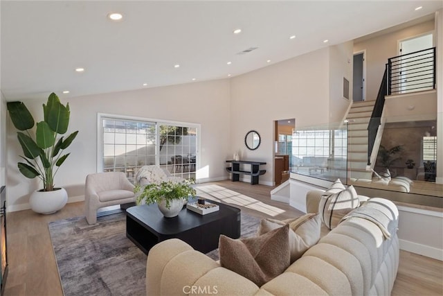 7372 Brian Ln, La Palma, CA 90623 - living area featuring recessed lighting, stairway, wood finished floors, and high vaulted ceiling