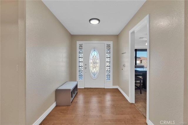 19055 Seaforth St, Hesperia, CA 92345 - foyer entrance featuring light wood-style flooring and a textured wall