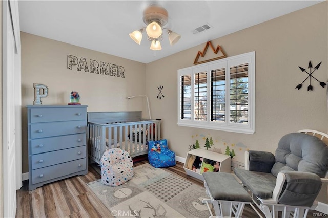 19055 Seaforth St, Hesperia, CA 92345 - bedroom with wood finished floors and a nursery area