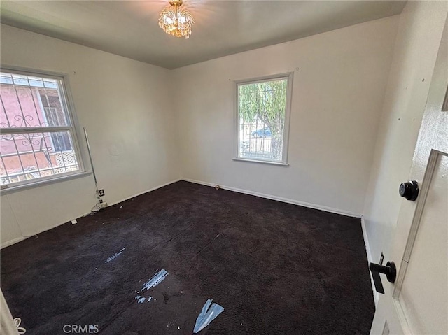 1418 W Magnolia St, Compton, CA 90220 - empty room with dark carpet and a chandelier