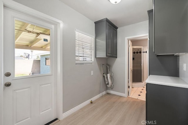 309 N Leland Ave, West Covina, CA 91790 - laundry room with healthy amount of natural light, cabinet space, and light wood-style floors