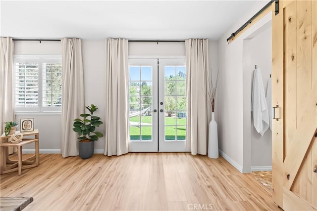 40630 Calle Torcida, Temecula, CA 92591 - doorway to outside featuring a barn door, light wood finished floors, and french doors