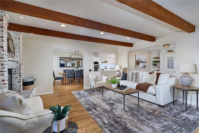 40630 Calle Torcida, Temecula, CA 92591 - living area featuring wood finished floors, a fireplace, a chandelier, beam ceiling, and recessed lighting