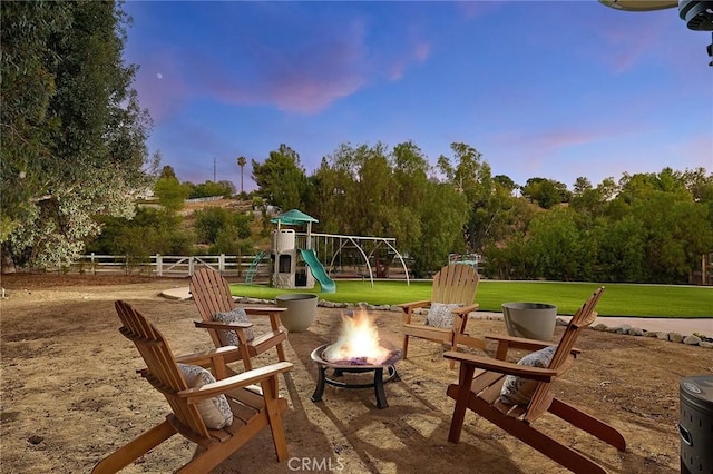 40630 Calle Torcida, Temecula, CA 92591 - patio terrace at dusk featuring an outdoor fire pit and a playground