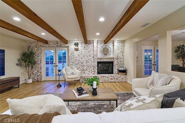 40630 Calle Torcida, Temecula, CA 92591 - living room featuring french doors, wood finished floors, beamed ceiling, a fireplace, and brick wall