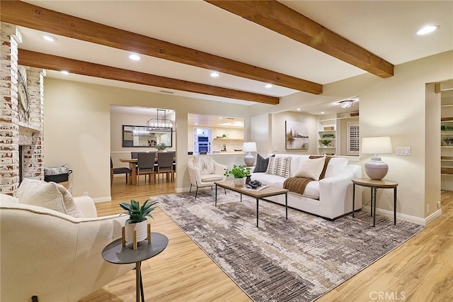 40630 Calle Torcida, Temecula, CA 92591 - living room with wood finished floors, recessed lighting, beam ceiling, a chandelier, and a brick fireplace