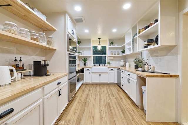 40630 Calle Torcida, Temecula, CA 92591 - kitchen with open shelves, appliances with stainless steel finishes, butcher block countertops, light wood-style floors, and recessed lighting