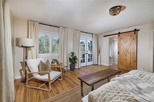 40630 Calle Torcida, Temecula, CA 92591 - bedroom with light wood-style flooring, a barn door, access to outside, and french doors