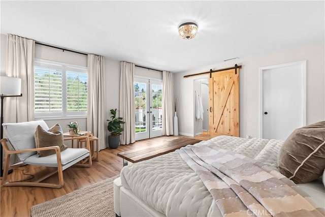 40630 Calle Torcida, Temecula, CA 92591 - bedroom featuring access to exterior, a barn door, and wood finished floors