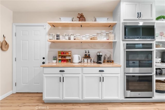 40630 Calle Torcida, Temecula, CA 92591 - indoor dry bar with appliances with stainless steel finishes and light wood-style flooring