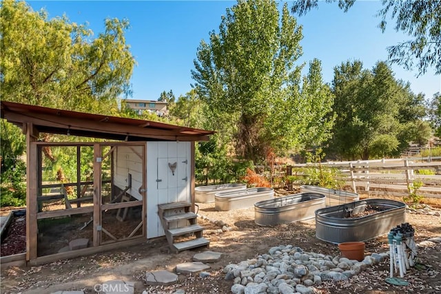 40630 Calle Torcida, Temecula, CA 92591 - view of yard with a vegetable garden, an outbuilding, and exterior structure