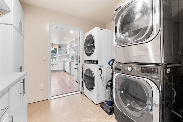40630 Calle Torcida, Temecula, CA 92591 - laundry area with stacked washer and clothes dryer and cabinet space