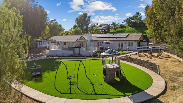 40630 Calle Torcida, Temecula, CA 92591 - rear view of house with an outdoor fire pit, a trampoline, solar panels, a patio area, and french doors