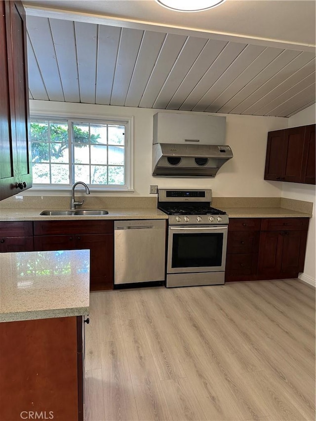 1322 S Walnut Ave, West Covina, CA 91790 - kitchen with stainless steel appliances, ventilation hood, light countertops, lofted ceiling, and light wood-style floors