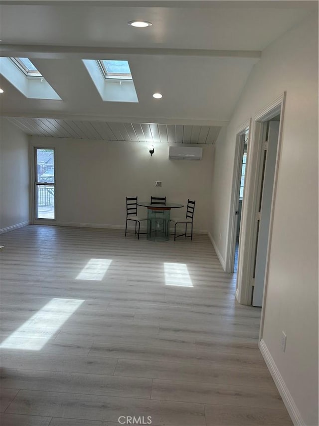 1322 S Walnut Ave, West Covina, CA 91790 - empty room featuring a skylight, light wood finished floors, and a wall unit AC