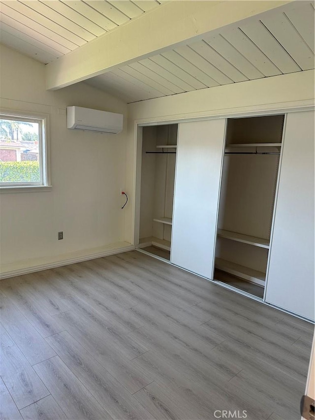 1322 S Walnut Ave, West Covina, CA 91790 - unfurnished bedroom with a wall unit AC, a wooden ceiling with exposed beams, and wood finished floors