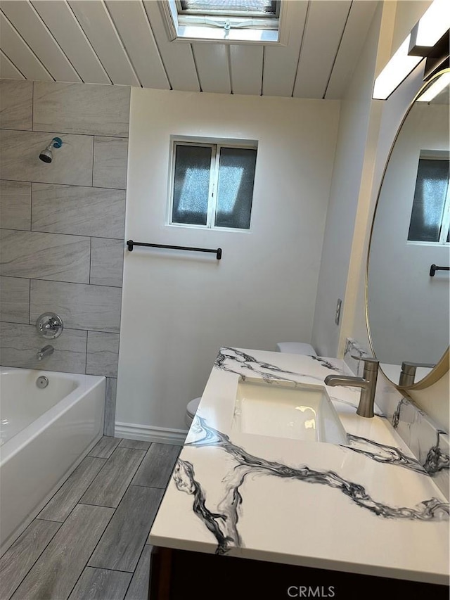 1322 S Walnut Ave, West Covina, CA 91790 - full bath with a skylight, vanity, wood finish floors, and shower / bathtub combination