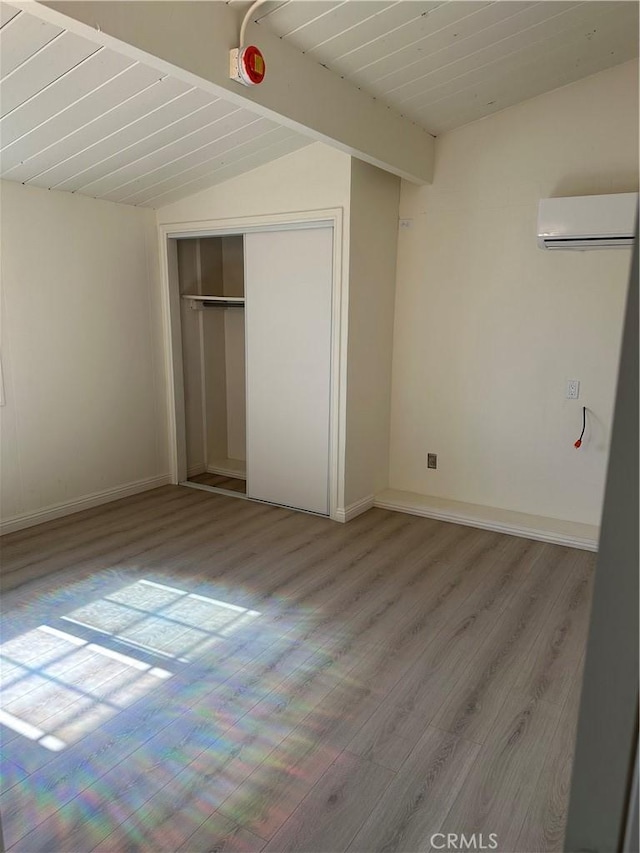 1322 S Walnut Ave, West Covina, CA 91790 - unfurnished bedroom featuring an AC wall unit, wood finished floors, and a closet