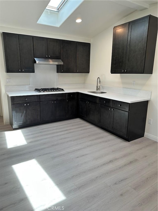 1322 S Walnut Ave, West Covina, CA 91790 - kitchen with a skylight, light wood-style floors, under cabinet range hood, lofted ceiling, and recessed lighting