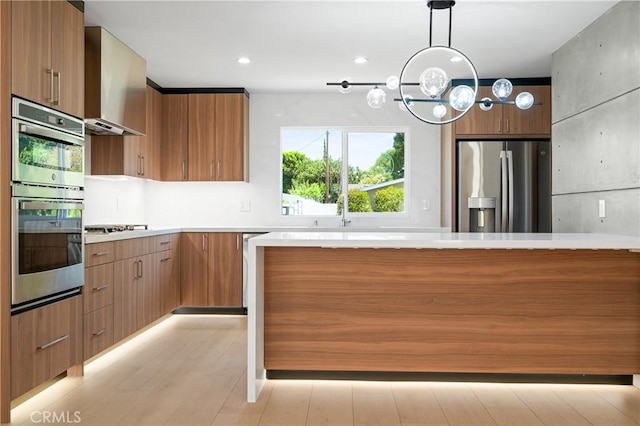 16701 Kalisher, Granada Hills, CA 91344 - kitchen featuring appliances with stainless steel finishes, modern cabinets, brown cabinets, pendant lighting, and wall chimney exhaust hood
