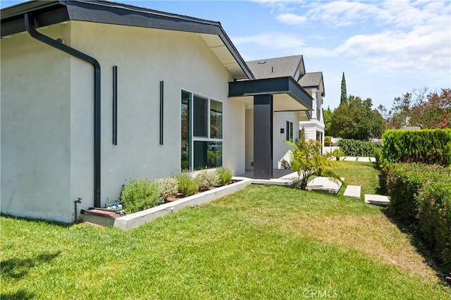 16701 Kalisher, Granada Hills, CA 91344 - back of house featuring stucco siding and a lawn