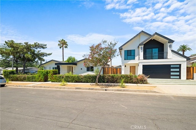 16701 Kalisher, Granada Hills, CA 91344 - contemporary house with an attached garage, driveway, a balcony, and stucco siding