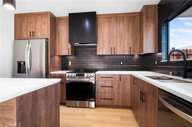 16701 Kalisher, Granada Hills, CA 91344 - kitchen featuring stainless steel appliances, range hood, light countertops, light wood-style flooring, and tasteful backsplash