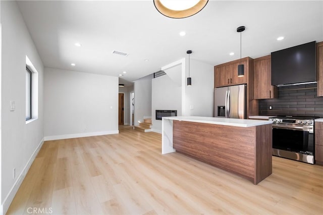 16701 Kalisher, Granada Hills, CA 91344 - kitchen with appliances with stainless steel finishes, exhaust hood, light wood finished floors, backsplash, and recessed lighting