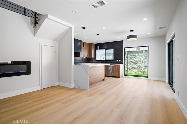 16701 Kalisher, Granada Hills, CA 91344 - kitchen featuring stainless steel dishwasher, light countertops, light wood-style flooring, backsplash, and recessed lighting