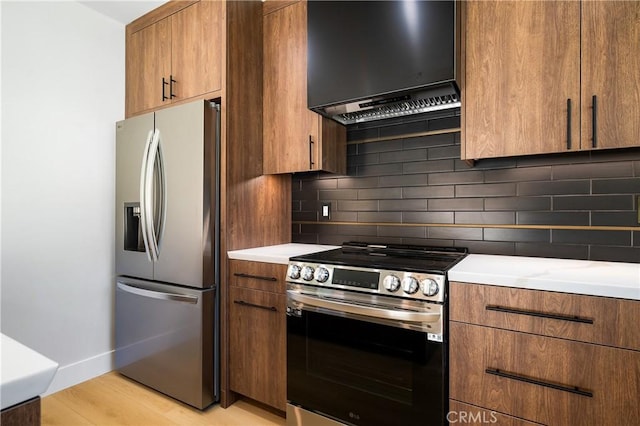 16701 Kalisher, Granada Hills, CA 91344 - kitchen featuring appliances with stainless steel finishes, wall chimney range hood, brown cabinetry, tasteful backsplash, and light countertops
