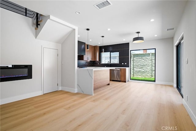 16701 Kalisher, Granada Hills, CA 91344 - kitchen with stainless steel dishwasher, light wood-type flooring, light countertops, decorative backsplash, and recessed lighting