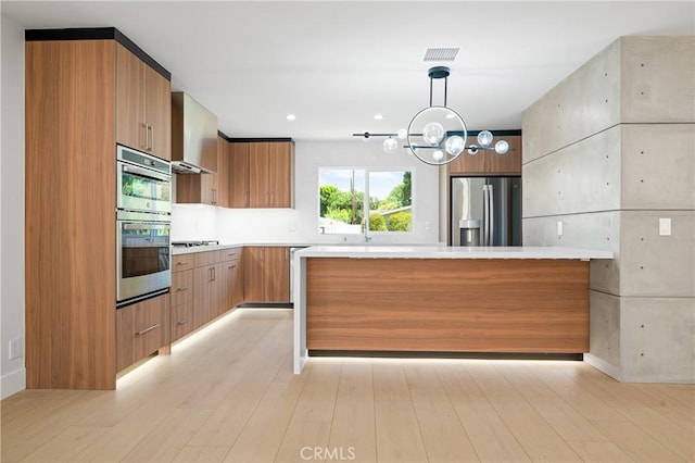 16701 Kalisher, Granada Hills, CA 91344 - kitchen featuring stainless steel appliances, modern cabinets, light countertops, and wall chimney range hood