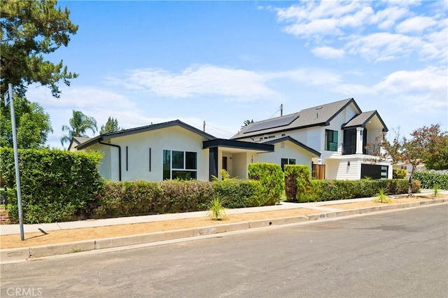 16701 Kalisher, Granada Hills, CA 91344 - view of front facade featuring stucco siding and solar panels