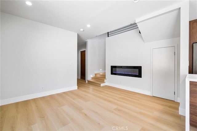 16701 Kalisher, Granada Hills, CA 91344 - unfurnished living room featuring a glass covered fireplace, light wood-style flooring, and recessed lighting