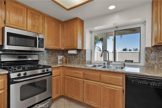 1850 Coolidge St, Corona, CA 92879 - kitchen with appliances with stainless steel finishes, decorative backsplash, light tile patterned flooring, light stone countertops, and brown cabinets
