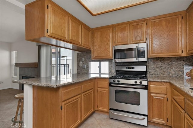 1850 Coolidge St, Corona, CA 92879 - kitchen featuring stainless steel appliances, light tile patterned flooring, and decorative backsplash