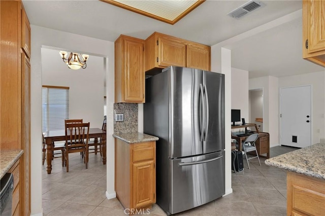 1850 Coolidge St, Corona, CA 92879 - kitchen featuring freestanding refrigerator, light tile patterned floors, a chandelier, decorative backsplash, and light stone counters