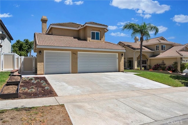1850 Coolidge St, Corona, CA 92879 - mediterranean / spanish home featuring concrete driveway, stucco siding, a gate, a tiled roof, and an attached garage