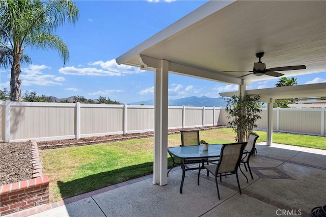 1850 Coolidge St, Corona, CA 92879 - fenced backyard featuring a ceiling fan, a patio area, outdoor dining space, and a mountain view
