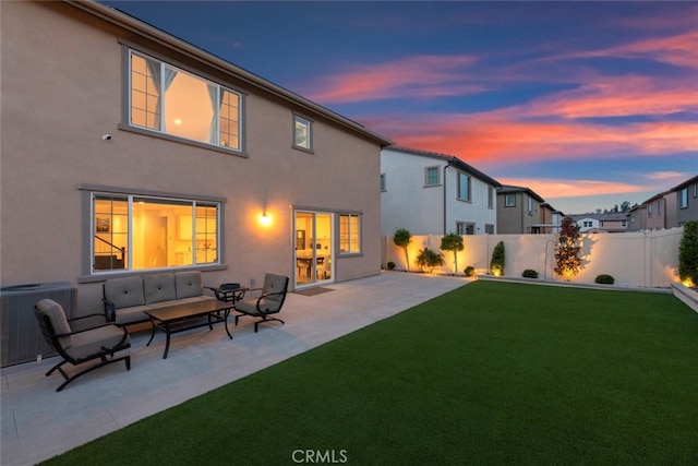 2227 Melogold Way, Corona, CA 92883 - back of property at dusk with a patio, stucco siding, and an outdoor hangout area