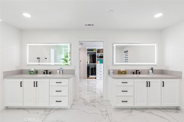 2227 Melogold Way, Corona, CA 92883 - bathroom with marble finish flooring, recessed lighting, two vanities, and a walk in closet