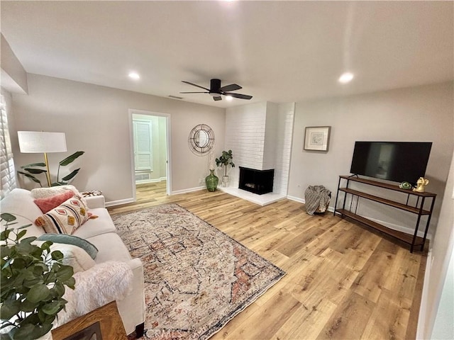 1521 S Pomona Ave Unit A23, Fullerton, CA 92832 - living area featuring ceiling fan, light wood finished floors, a brick fireplace, and recessed lighting