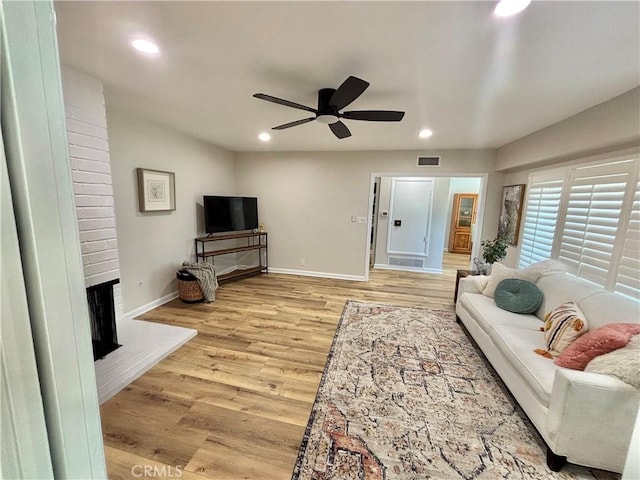 1521 S Pomona Ave Unit A23, Fullerton, CA 92832 - living room featuring a ceiling fan, light wood finished floors, recessed lighting, and a brick fireplace