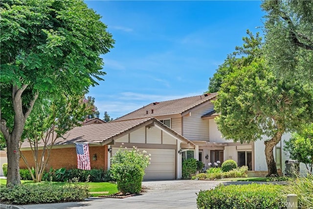 652 Via Zapata, Riverside, CA 92507 - view of front of property featuring a tile roof, an attached garage, driveway, and stucco siding