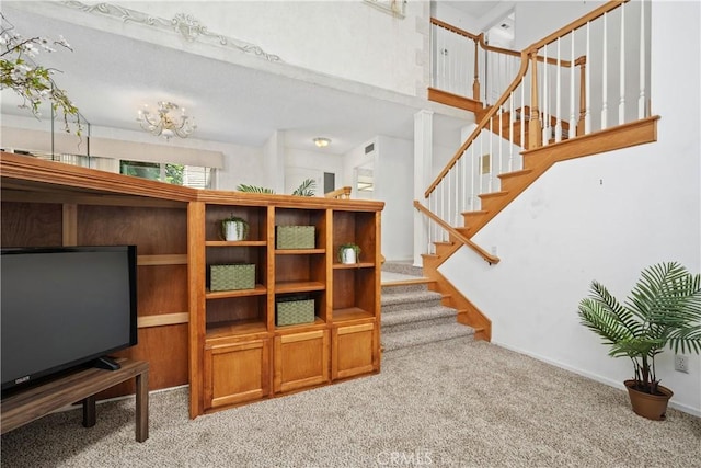 652 Via Zapata, Riverside, CA 92507 - living area with light carpet, stairs, and a towering ceiling